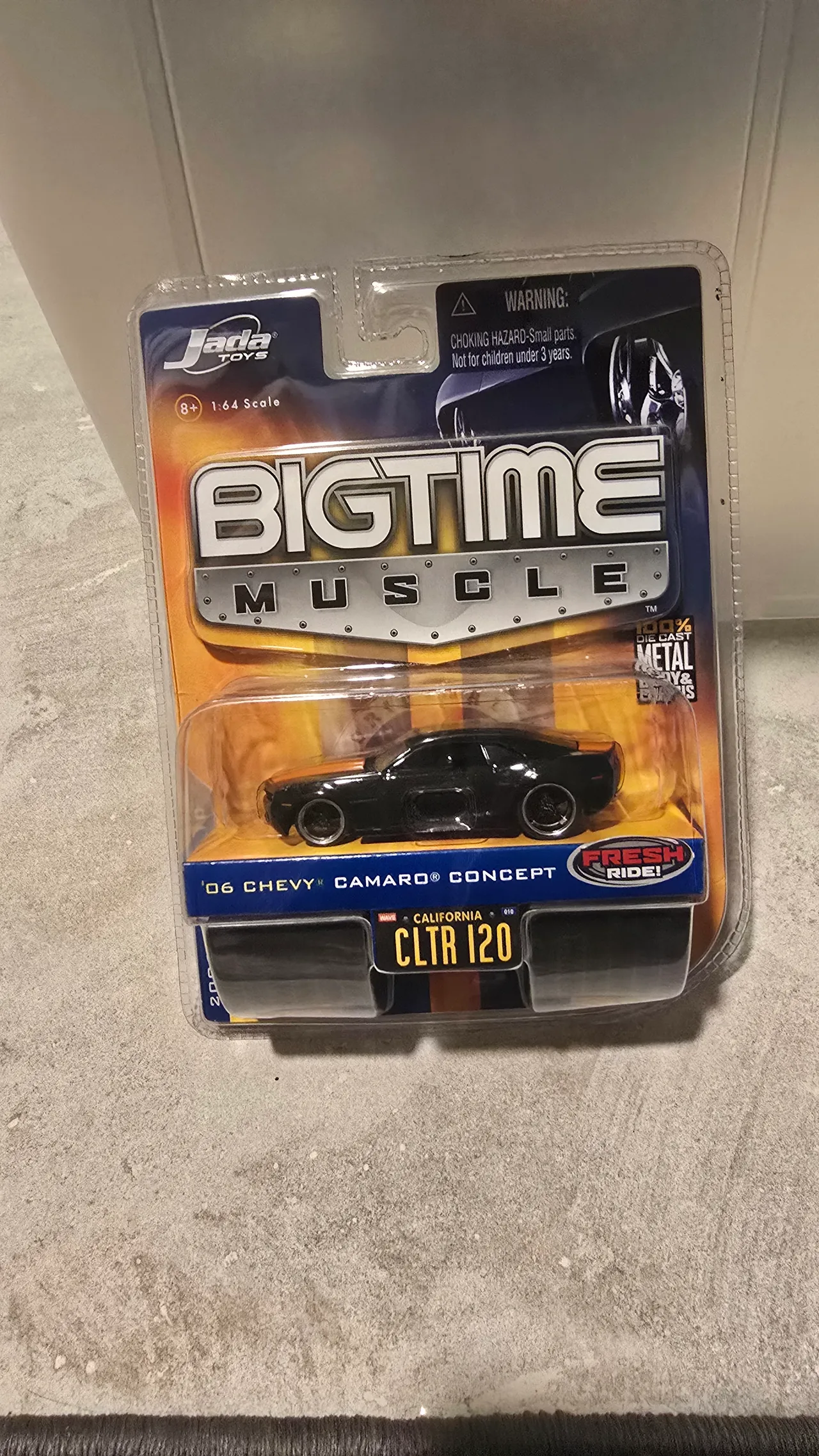 Black 2006 Chevy Camaro Concept with orange stripes by Jada Toys, Big Time Muscle, in its blister pack
