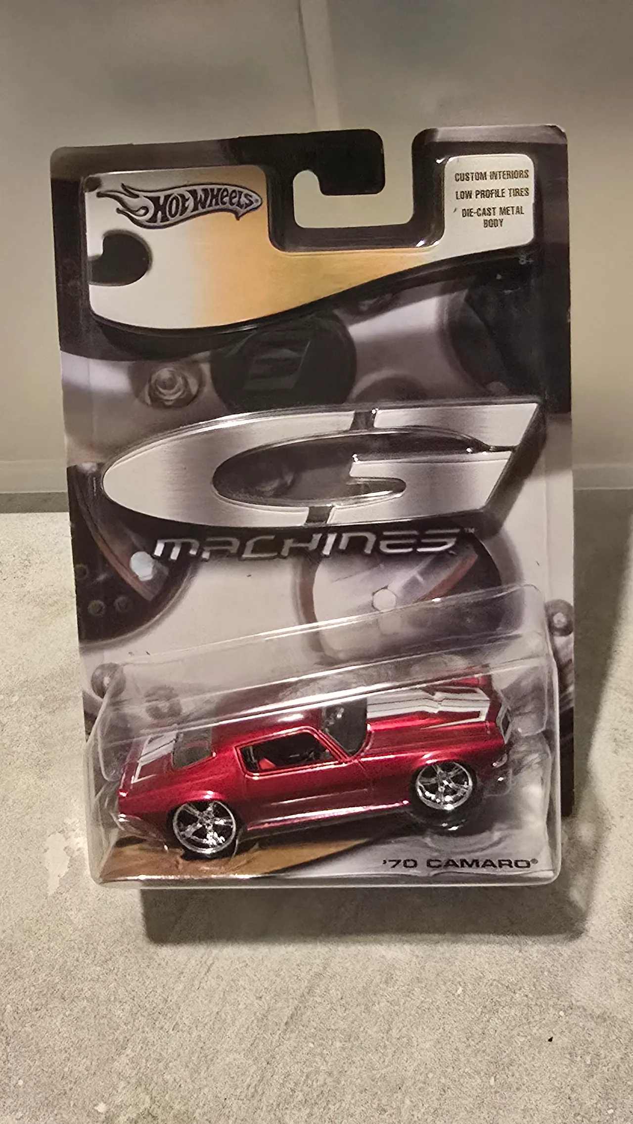Dark red 1970 Camaro with white stripes and custom wheels by Hot Wheels, G Machines, in its blister pack