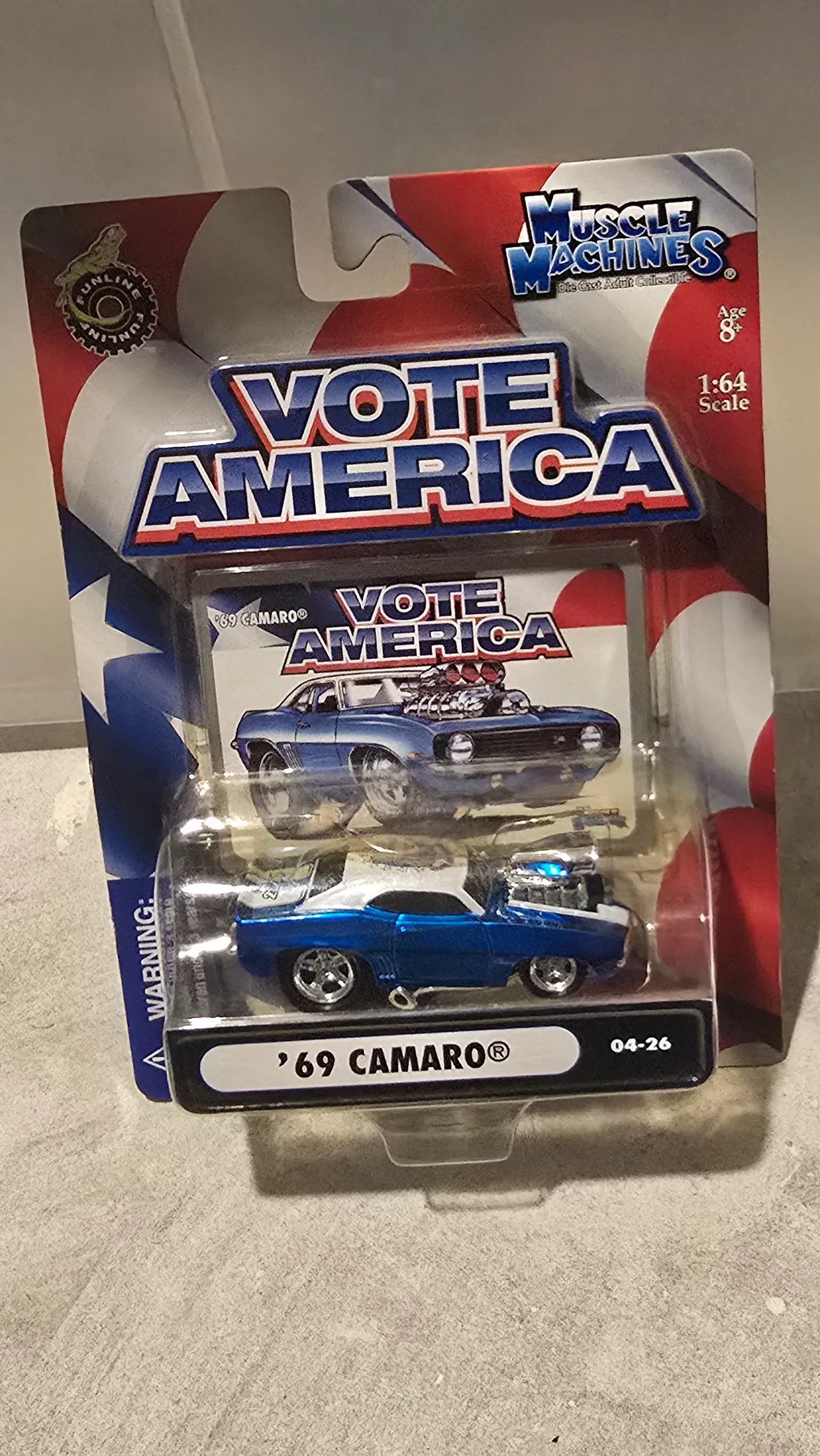 Metallic blue 1969 Camaro with a white roof and a big chrome blower by Muscle Machines, Vote America, in its blister pack