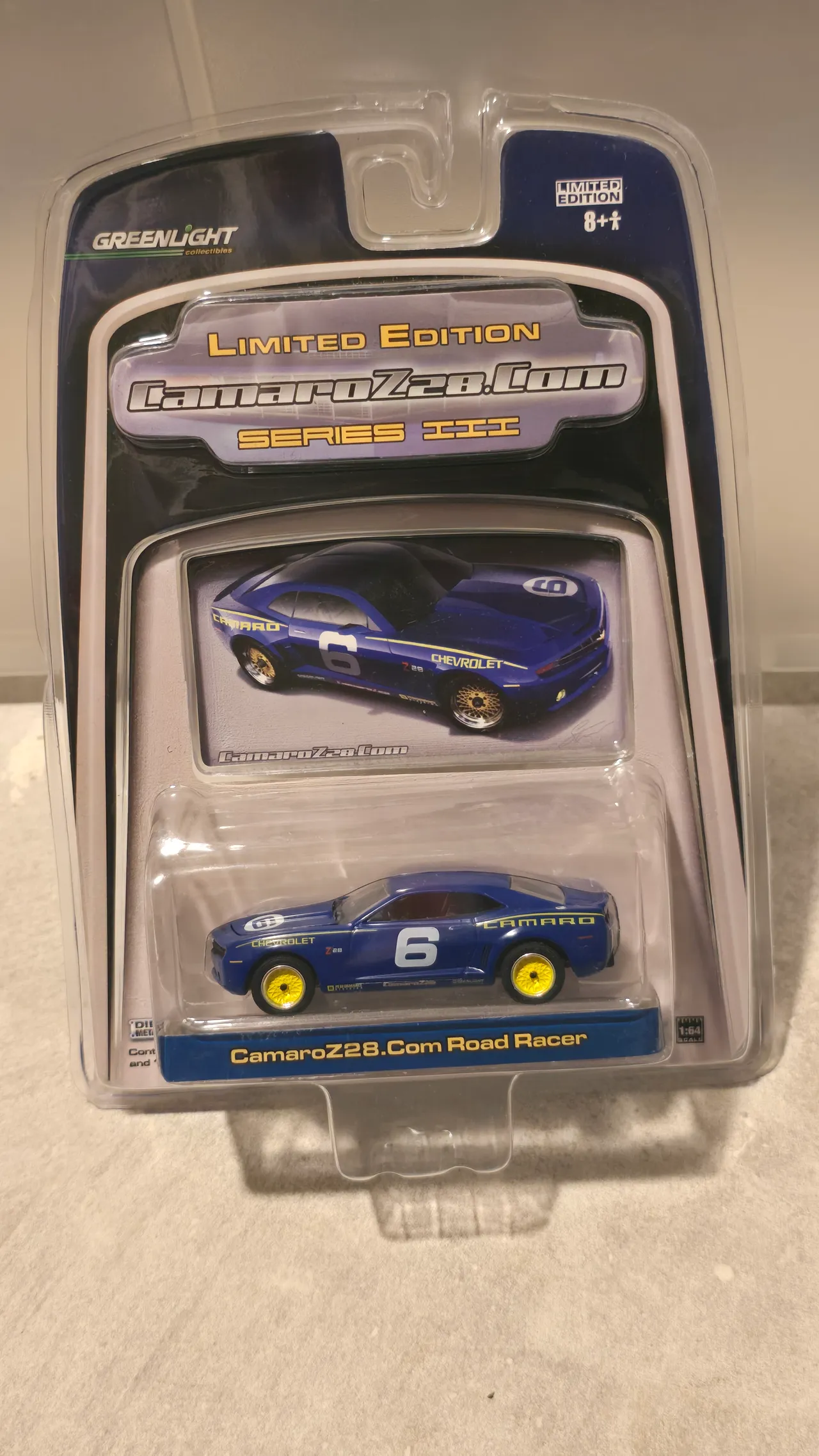 Blue Chevy Camaro road racer with a white number 6 and yellow stripes by Greenlight, CamaroZ28.Com Series III, in its blister pack