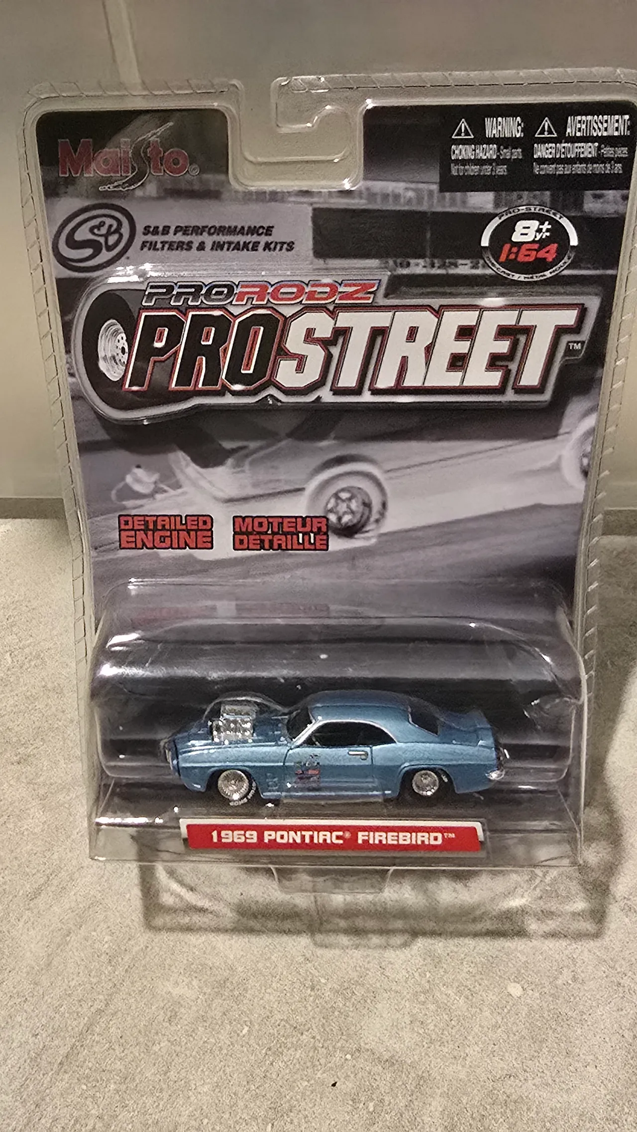 Light blue 1969 Pontiac Firebird drag car with a chrome blower by Maisto, Pro Rodz Pro Street, in its blister pack