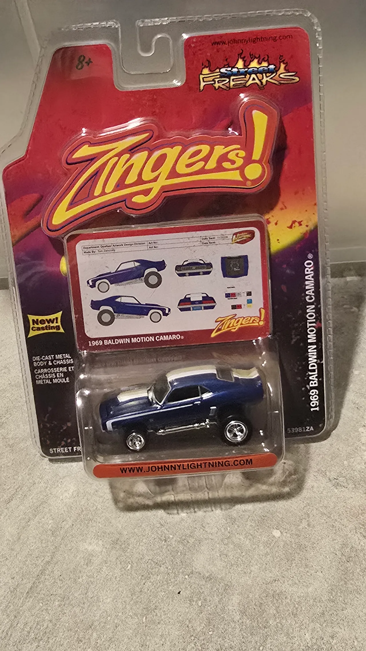 Dark blue 1969 Baldwin Motion Camaro with white stripes and a raised stance by Johnny Lightning, Street Freaks Zingers, in its blister pack