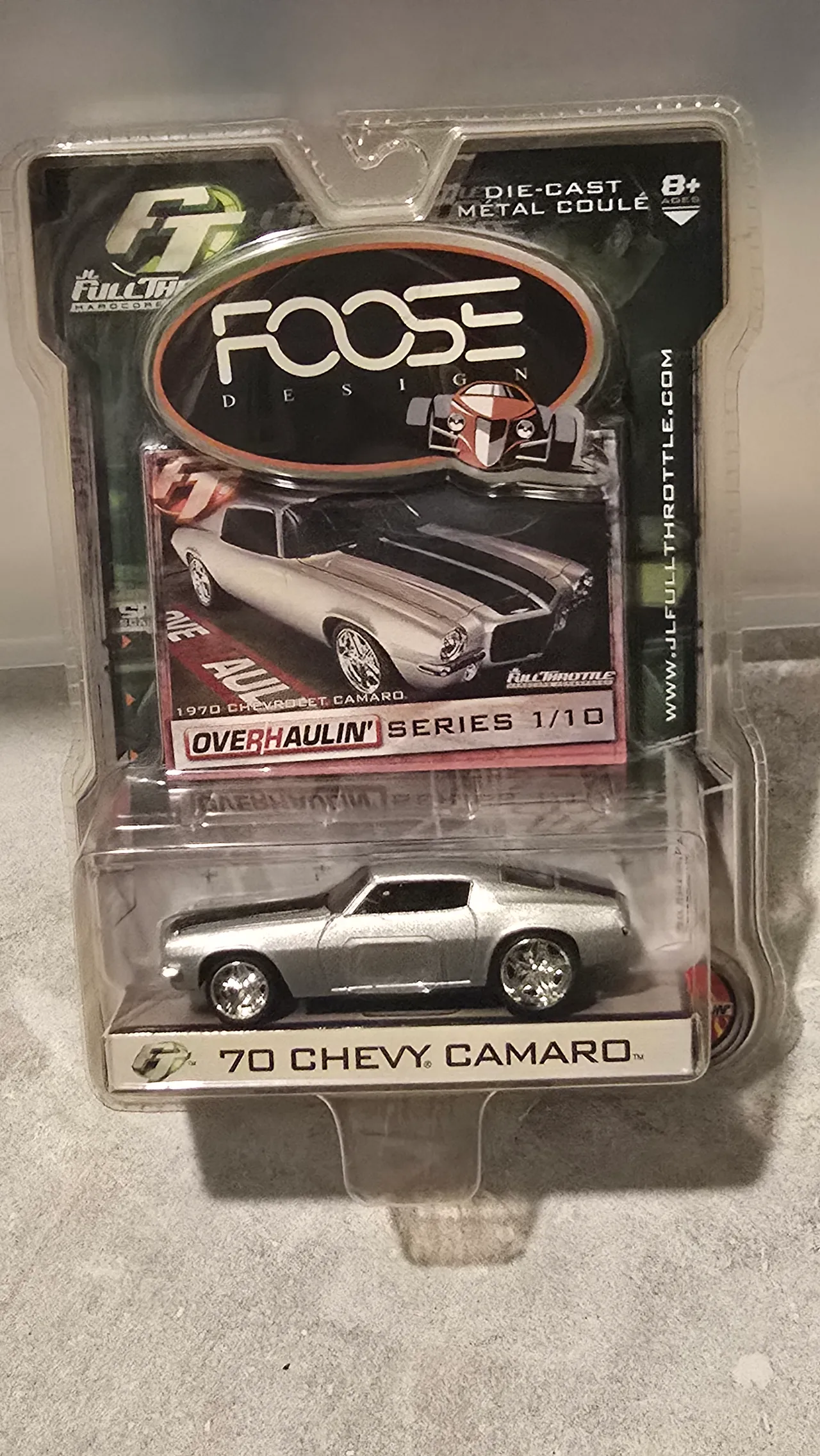 Silver 1970 Chevy Camaro with black stripes and custom wheels by Johnny Lightning, Foose Design Overhaulin' Series, in its blister pack
